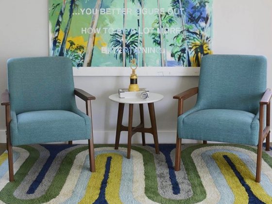 A yellow, blue, and green zig zag mid-century rug.