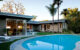 MCM backyard with pool and floor-to-ceiling windows connecting to the interior