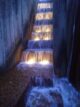 water falls down the illuminated steps of the Keller Fountain