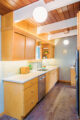 wood cabinets and ceiling beams in MCM kitchen