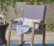 Outdoor rocking chair. Dark grey cushions and Acadia wood with teak finish.