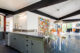 Kitchen and dining area with sage green cabinets and chairs