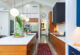 Kitchen with wooden cabinets and angled ceilings