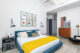 Bedroom with mustard accent throw and MCM furniture