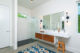 Mid-Century bathroom with floating vanity and sink and tiled shower