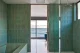 Heath Ceramics dimensional tile in green bathroom with ocean view