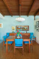 dining area with blue upholstered chairs in 1960s MCM home