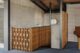 concrete block walls and wood paneled screens surrounding staircase