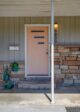 peach exterior door and stone siding on Boise MCM home exterior