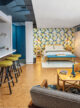 renovated basement in Omaha home with cork flooring and yellow and green wallpaper